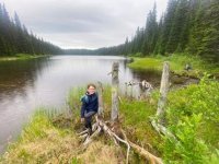 A person standing on a log next to a body of water AI-generated content may be incorrect. A person standing on a log next to a body of water AI-generated content may be incorrect.